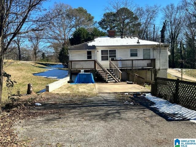 rear view of property with a deck