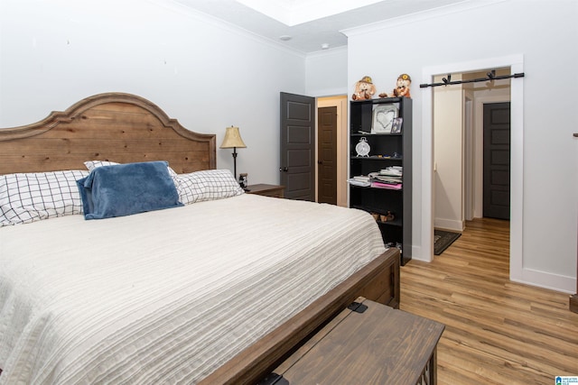 bedroom featuring wood-type flooring and ornamental molding