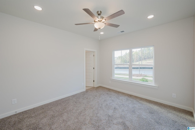 unfurnished room featuring a ceiling fan, carpet, baseboards, and visible vents
