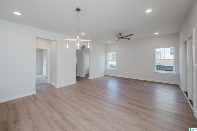 spare room with a ceiling fan, recessed lighting, baseboards, and light wood-type flooring