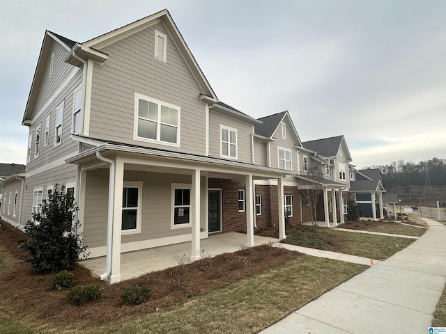 view of front of property with covered porch and a front lawn