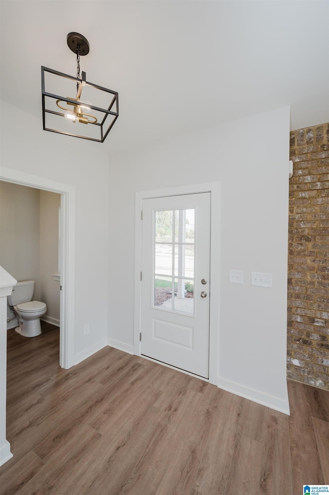 interior space with wood-type flooring and a chandelier