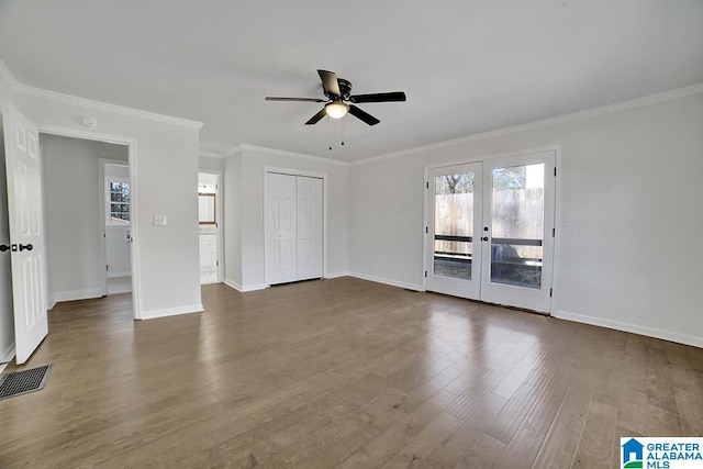 interior space featuring ornamental molding, dark wood-type flooring, ceiling fan, and french doors