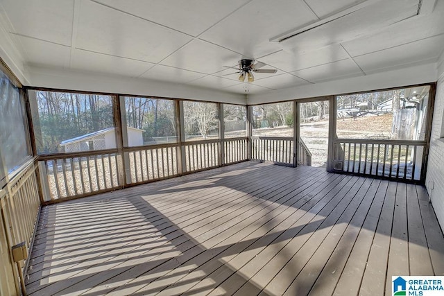 unfurnished sunroom featuring ceiling fan