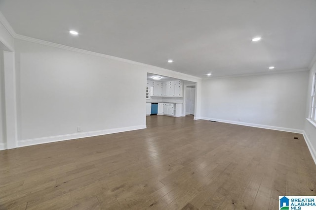 unfurnished living room with ornamental molding and dark wood-type flooring