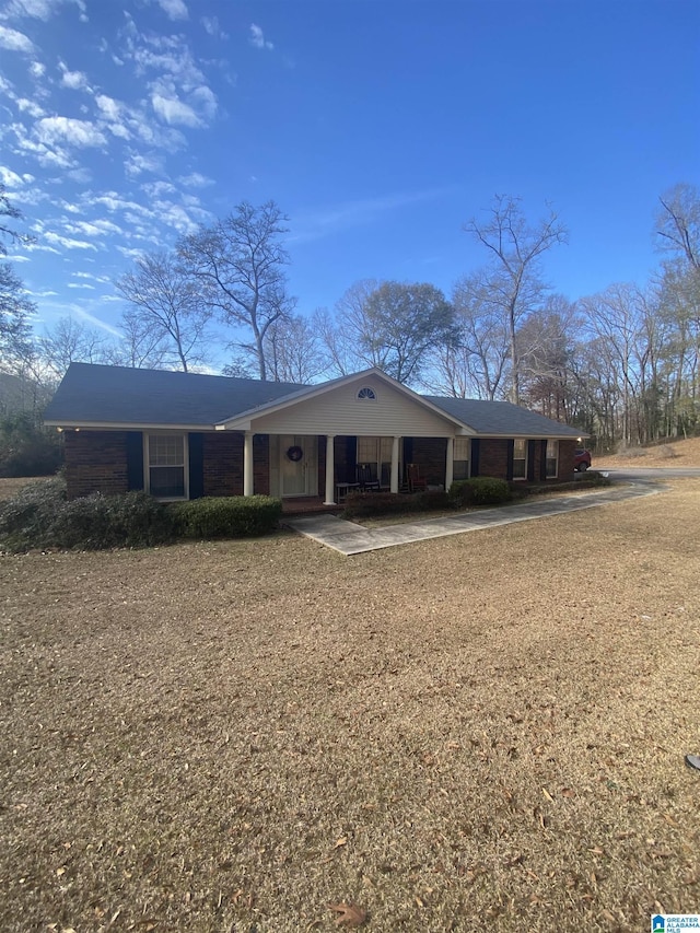 view of front of house featuring covered porch and concrete driveway