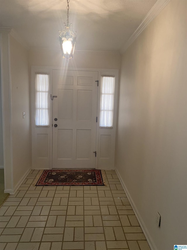 foyer entrance featuring baseboards, ornamental molding, brick floor, and a notable chandelier