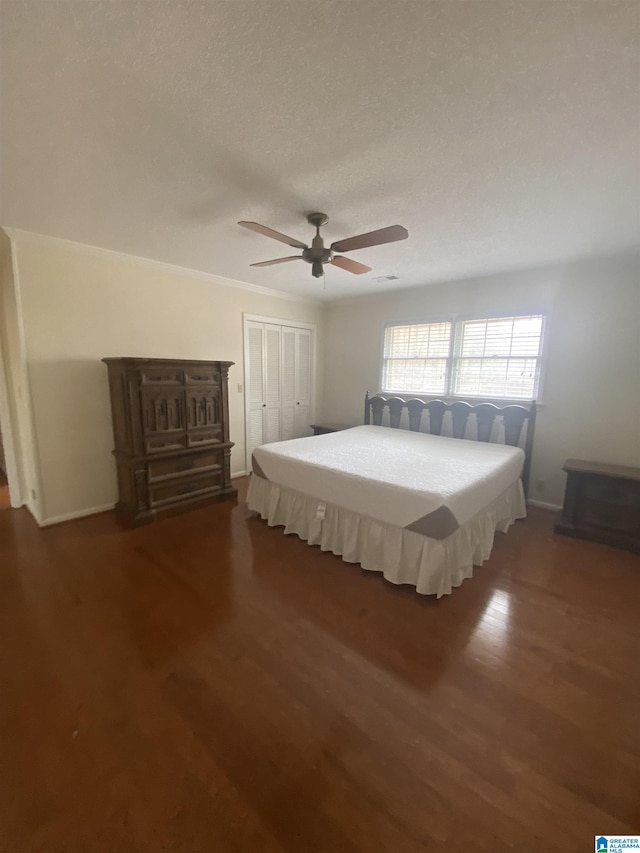bedroom with baseboards, a closet, and wood finished floors