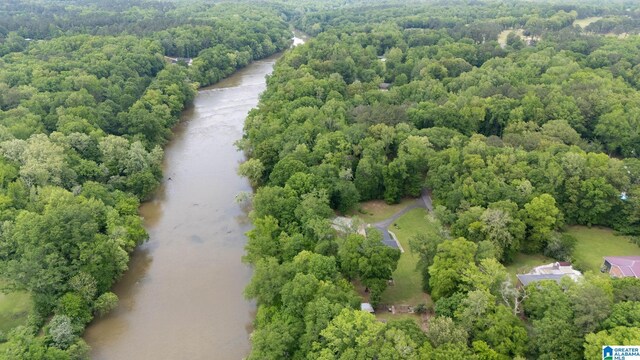birds eye view of property featuring a view of trees