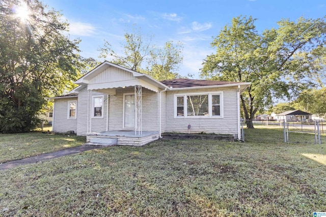 bungalow-style home featuring a front lawn