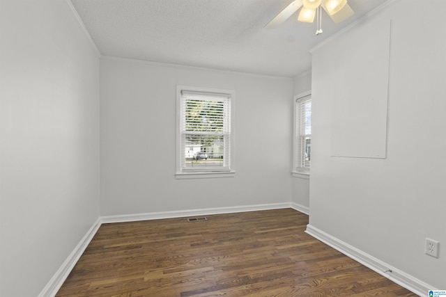 unfurnished room with ornamental molding, dark wood-type flooring, a textured ceiling, and ceiling fan