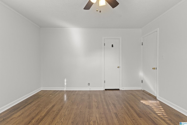 empty room with a textured ceiling, ceiling fan, crown molding, and dark hardwood / wood-style floors