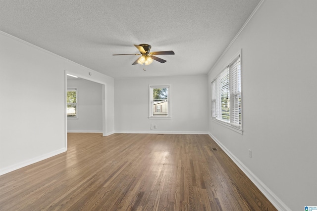 spare room with ceiling fan, dark hardwood / wood-style flooring, and a textured ceiling