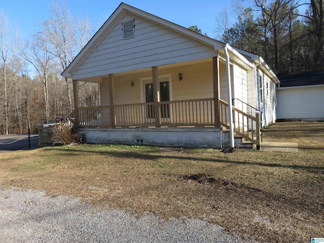 view of front of property with a front yard and covered porch