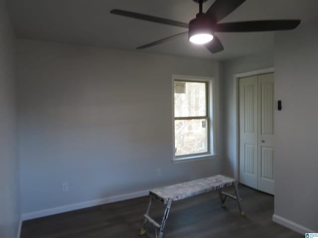 unfurnished room with dark hardwood / wood-style flooring and ceiling fan