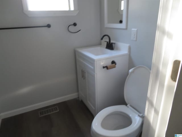 bathroom featuring toilet and vanity