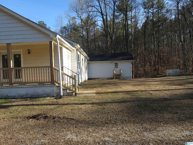 view of side of home featuring a yard