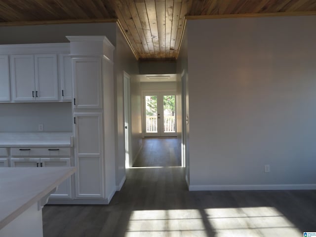 kitchen with wood ceiling, ornamental molding, french doors, dark hardwood / wood-style floors, and white cabinets