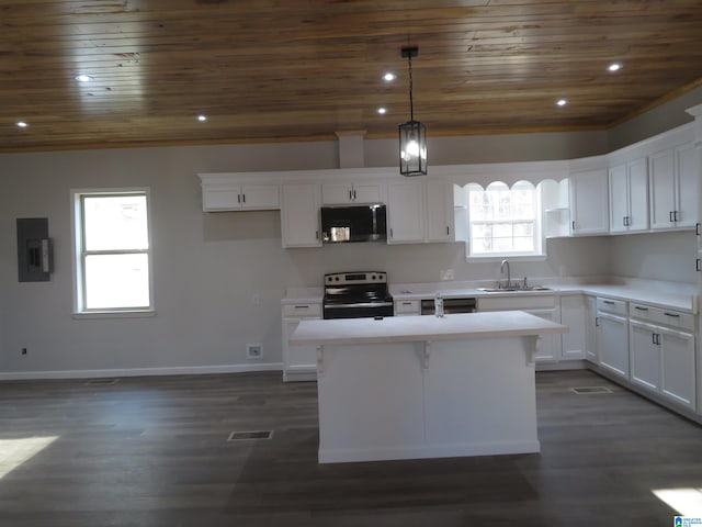 kitchen featuring stainless steel appliances, white cabinetry, decorative light fixtures, and a kitchen island