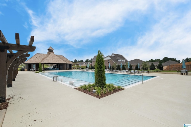 view of swimming pool with a gazebo and a patio area