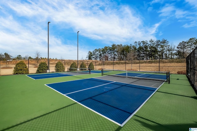 view of tennis court featuring basketball hoop