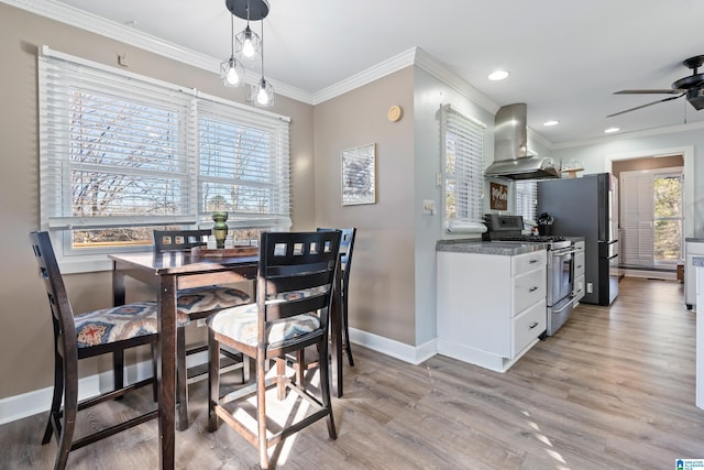 dining space with ceiling fan, ornamental molding, and light hardwood / wood-style flooring