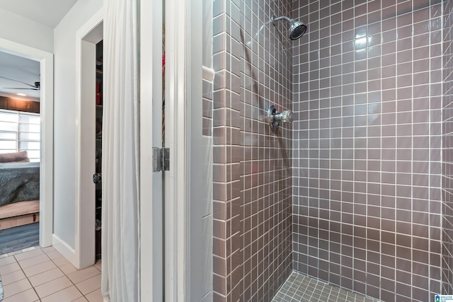 bathroom with tile patterned flooring and tiled shower