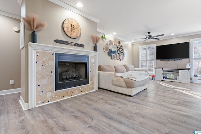 living room with ceiling fan, crown molding, and wood-type flooring