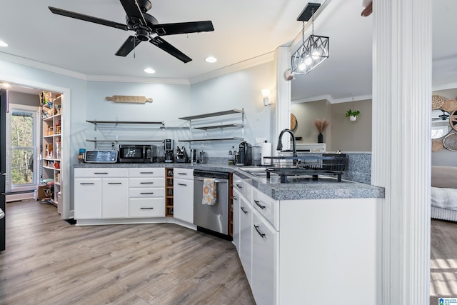 kitchen with white cabinetry, stainless steel dishwasher, hanging light fixtures, and sink