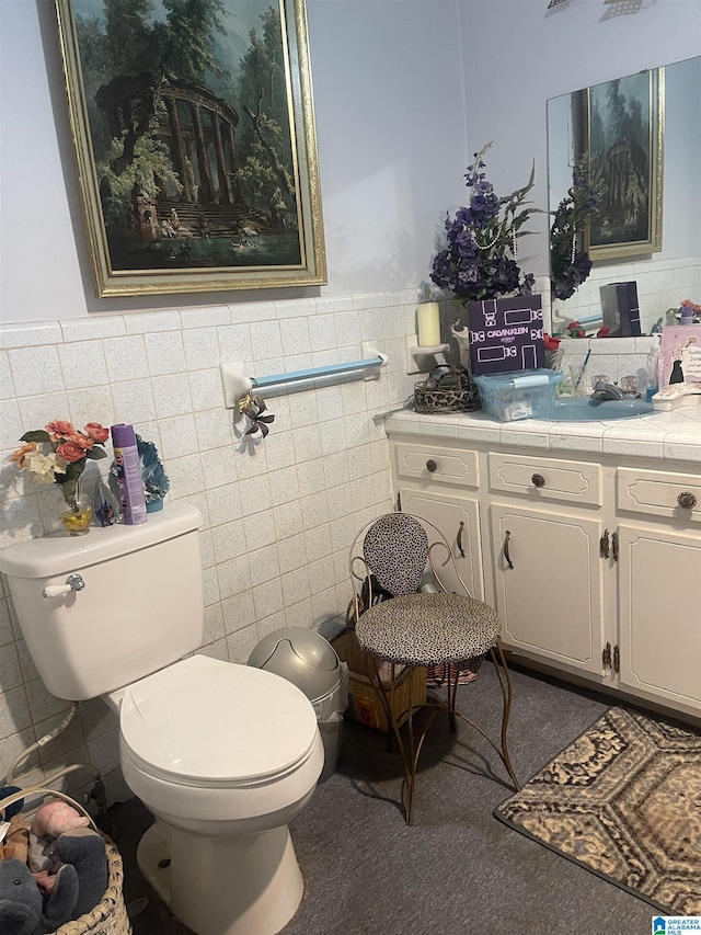 bathroom with tile walls, toilet, and vanity