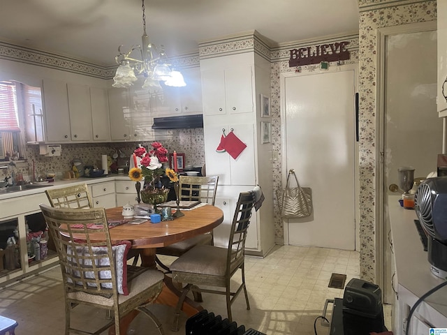 kitchen featuring sink, an inviting chandelier, and pendant lighting