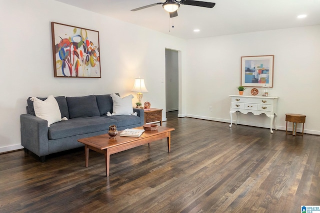 living room featuring ceiling fan and dark hardwood / wood-style flooring