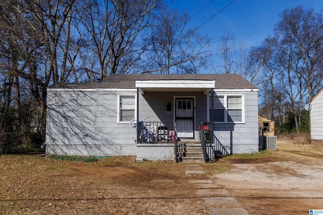 bungalow with a porch and central AC unit