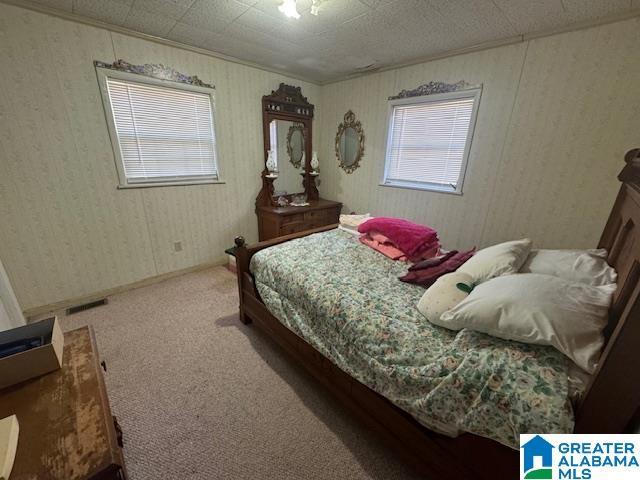 carpeted bedroom with crown molding