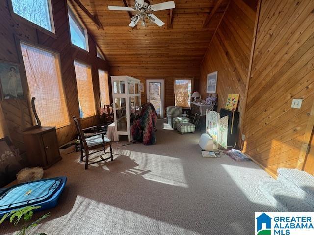 interior space featuring high vaulted ceiling, carpet floors, ceiling fan, and a wealth of natural light