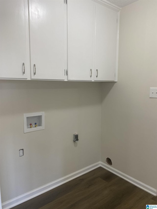 washroom with cabinets, dark hardwood / wood-style flooring, and washer hookup