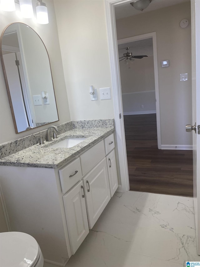 bathroom featuring ceiling fan, vanity, and toilet