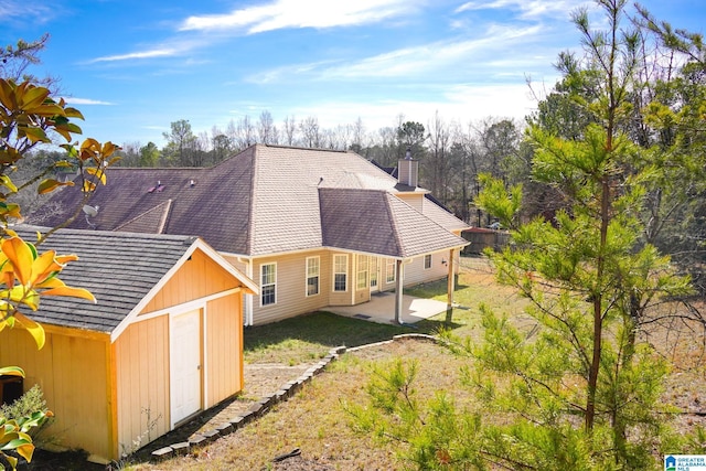 exterior space with a yard, a patio, and a shed