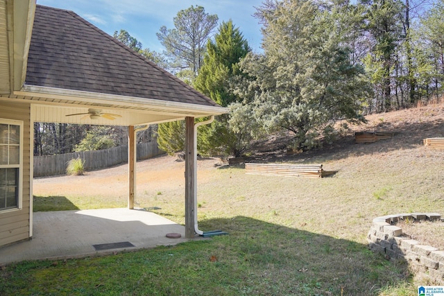 view of yard with ceiling fan and a patio