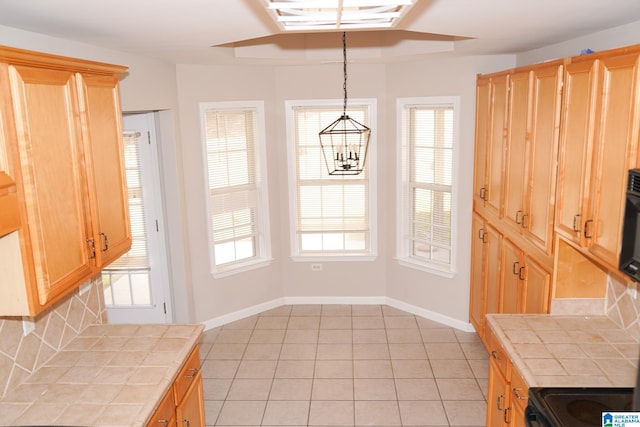 unfurnished dining area featuring light tile patterned floors and an inviting chandelier