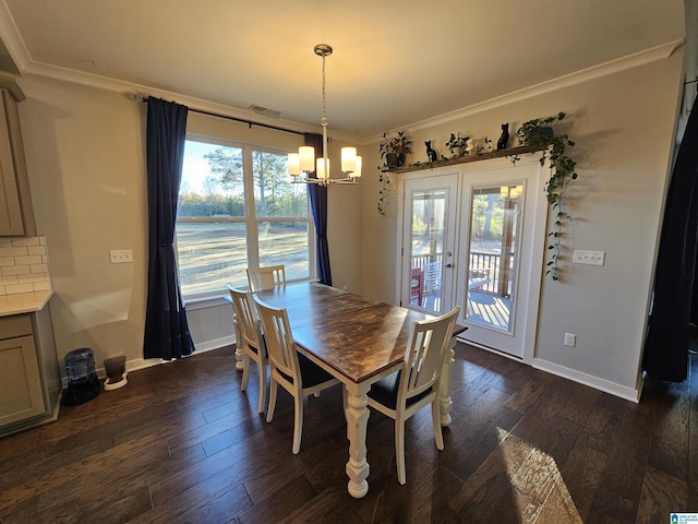 dining space with a notable chandelier, crown molding, and dark hardwood / wood-style floors