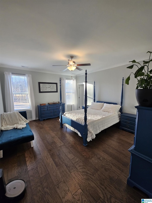 unfurnished bedroom featuring dark wood-type flooring, ceiling fan, and crown molding