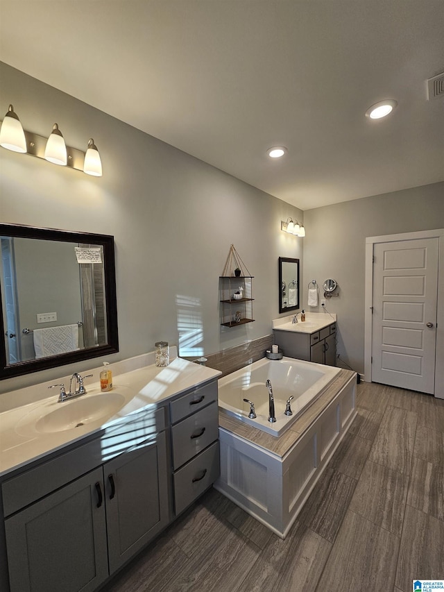 bathroom featuring vanity and a tub to relax in