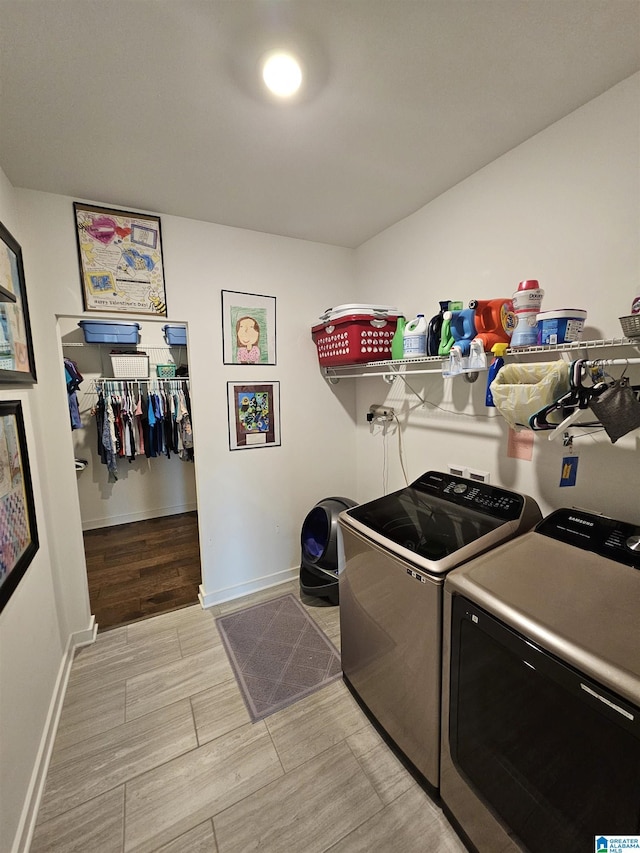 clothes washing area with separate washer and dryer