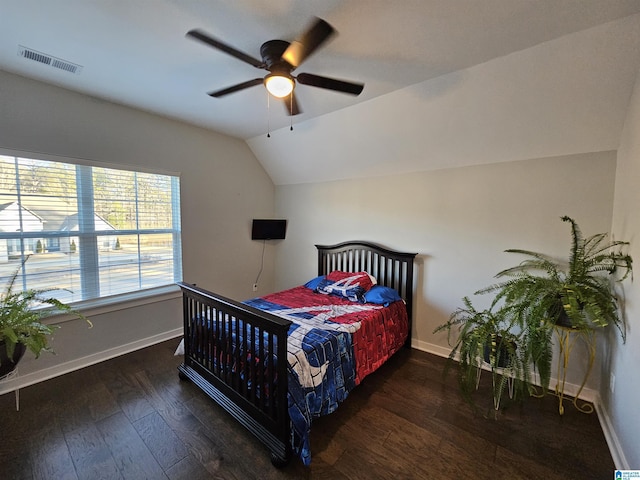 bedroom featuring lofted ceiling, dark hardwood / wood-style flooring, and ceiling fan