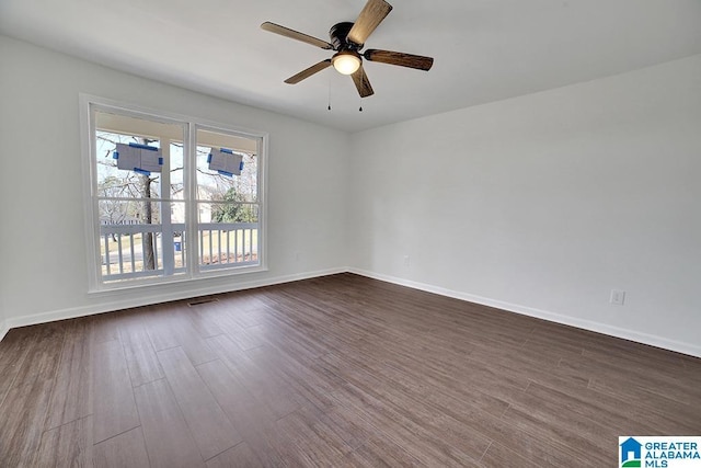 spare room featuring ceiling fan and dark hardwood / wood-style floors