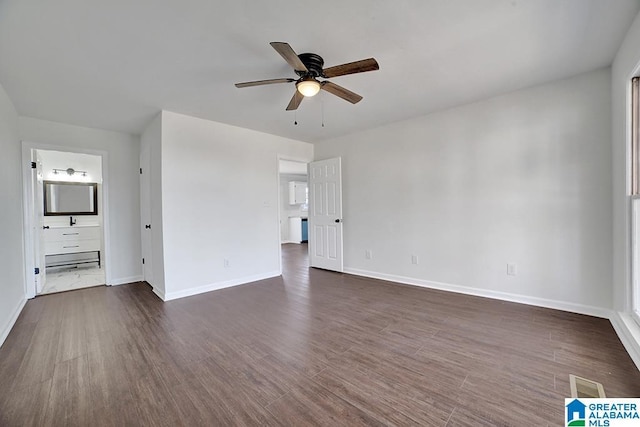 spare room with ceiling fan and dark hardwood / wood-style flooring