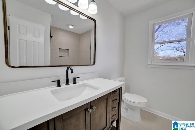 bathroom with toilet, a shower, and vanity