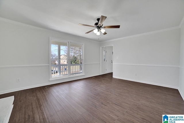 empty room featuring ceiling fan, ornamental molding, and dark hardwood / wood-style flooring