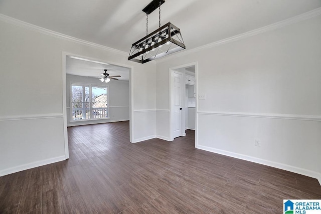 spare room featuring dark wood-type flooring, ceiling fan, and ornamental molding